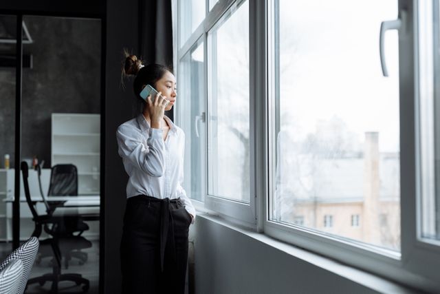person%20standing%20in%20a%20window%20on%20a%20cell%20phone person%20standing%20in%20a%20window%20on%20a%20cell%20phone